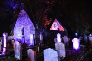 Alloway Auld Kirk up lit at night time by purple lights